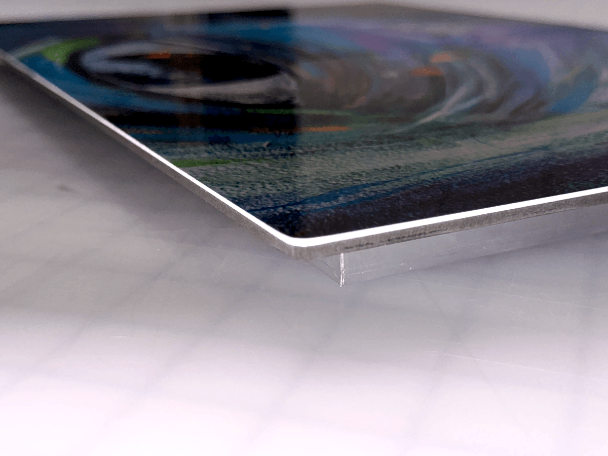 Close view of a finished aluminum print and gallery-edge mounting option